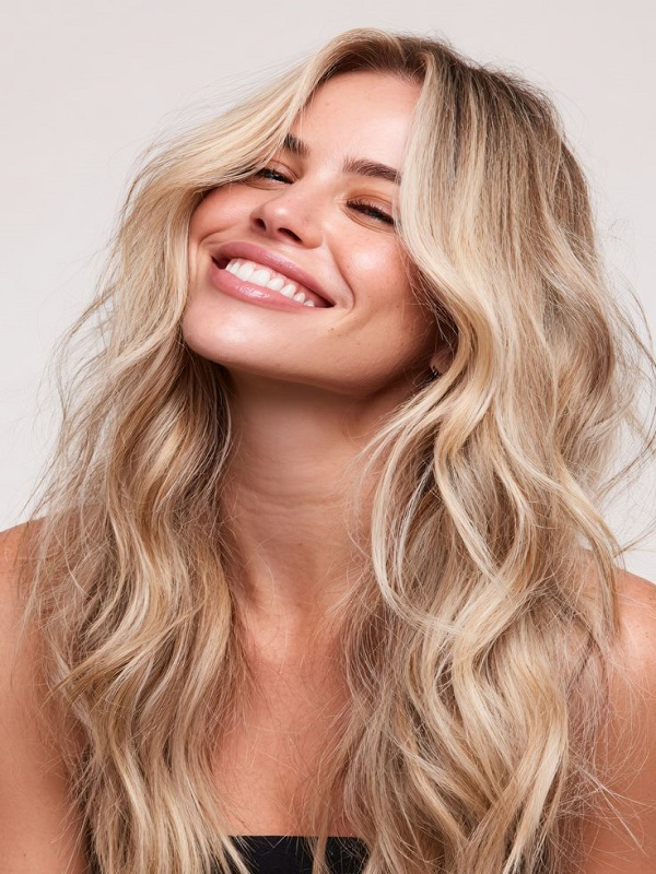 Woman wearing natural clip-in human hair extensions with added volume and length