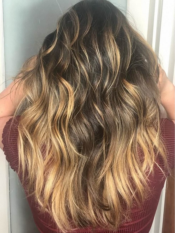 Woman showing natural hair color blending with human hair extensions