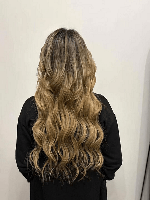 Woman with full volume genius weft human hair extensions natural look