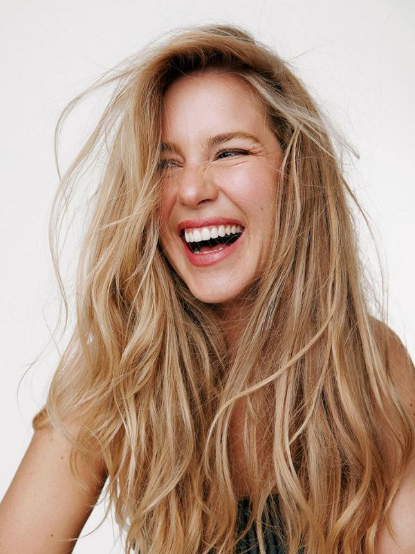 Woman with seamless tape-in hair extensions blended naturally into long hair